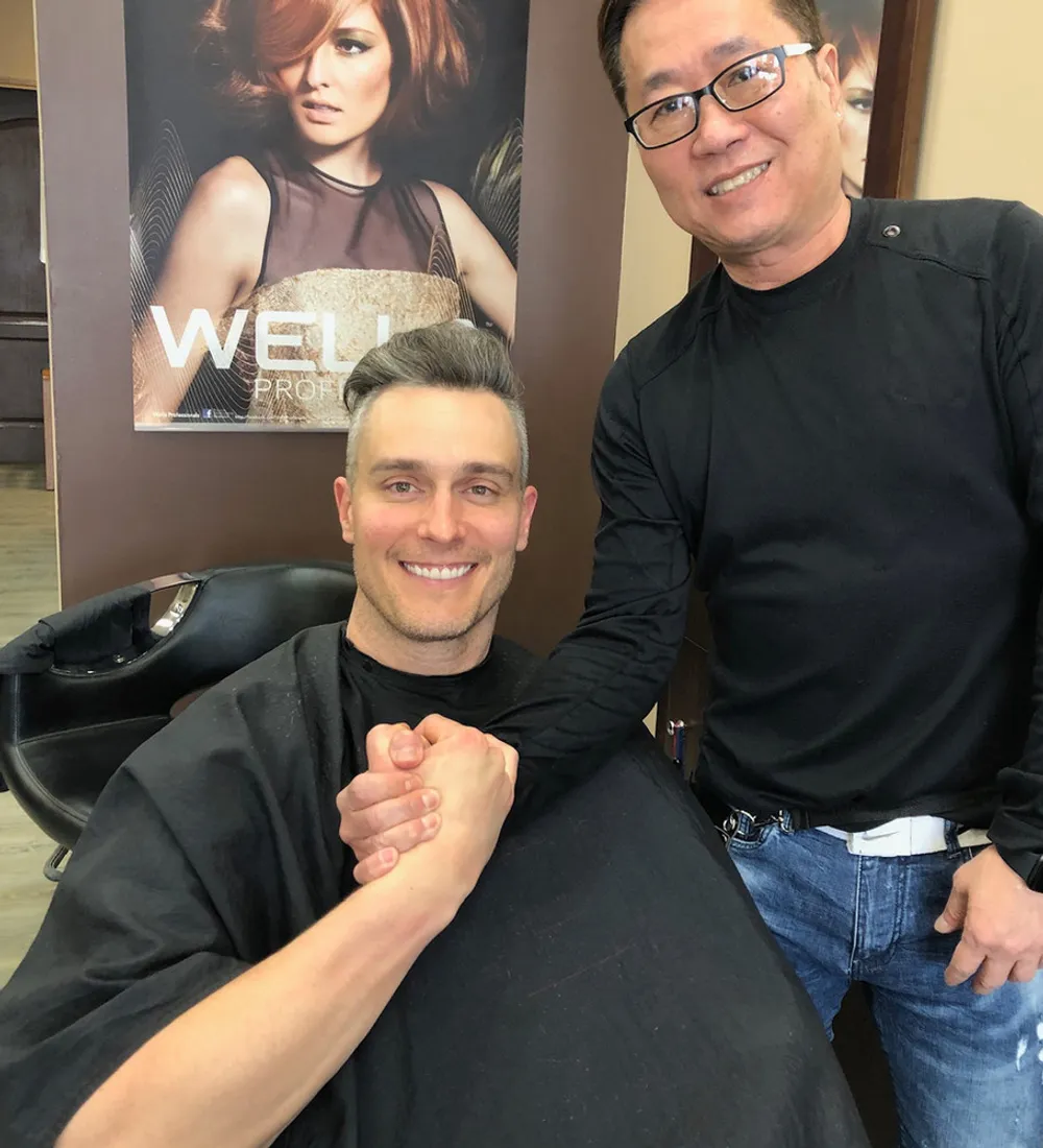 Director Kevin with a happy client in the Artistic Salon chair