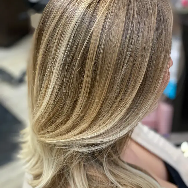 Soft blonde highlights with a smooth blow-dry finish
