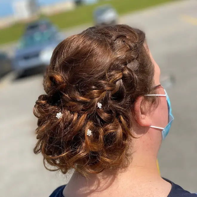 Braided bridal updo with floral pins